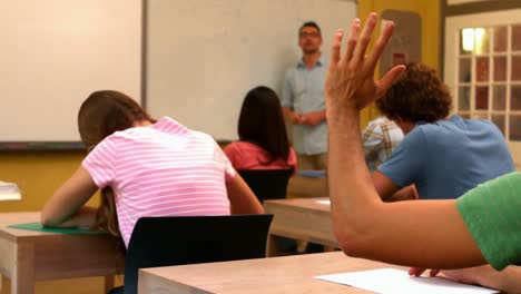 student putting up his hand in class