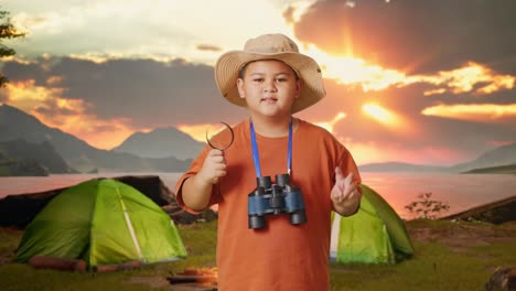 boy exploring nature with binoculars and magnifying glass at sunset