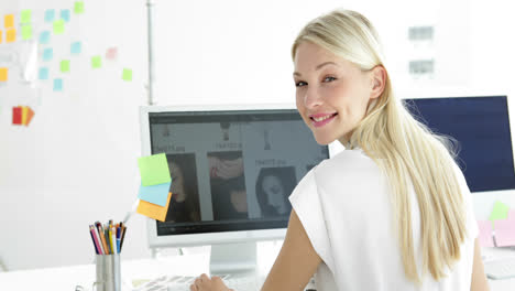 Rear-view-of-attractive-creative-designer-working-on-her-computer-