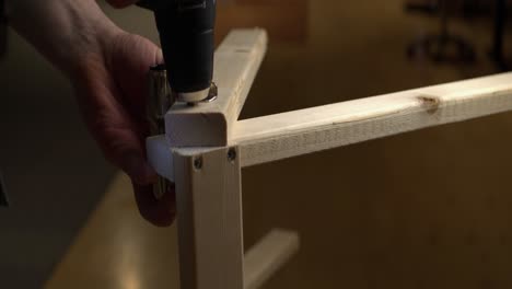 holes drilled into clamped pine lumber for diy project, narrow focus