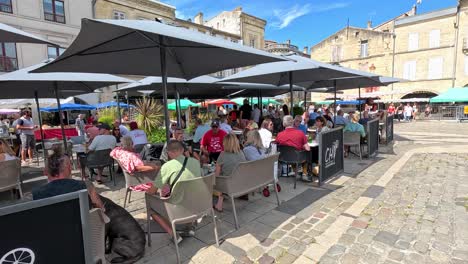 people enjoying a sunny day at a café