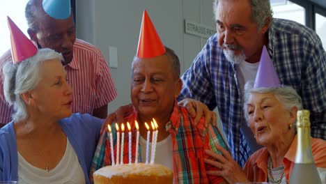 senior man celebrating his birthday with friends 4k