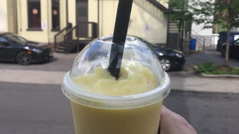 cerca de un hombre que sostiene un té de burbujas batido de plátano fresco en toronto, ontario, canadá