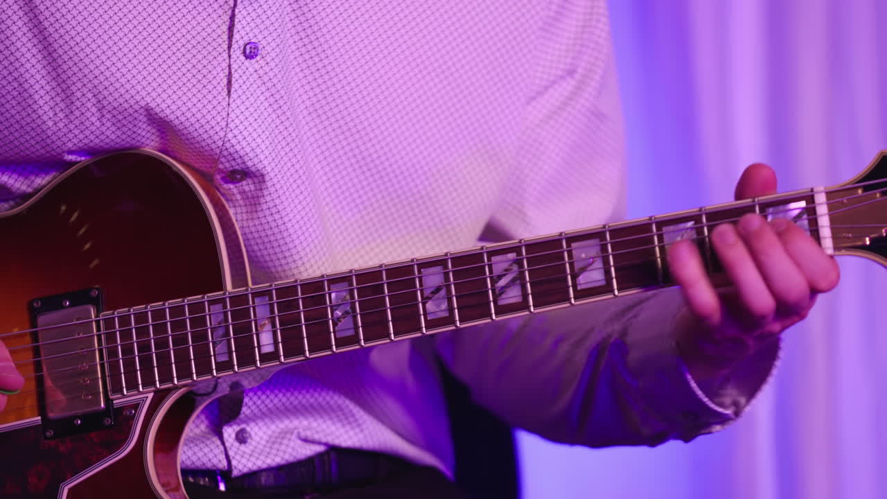 Person's Hands Playing Electric Guitar In The Studio. - closeup shot