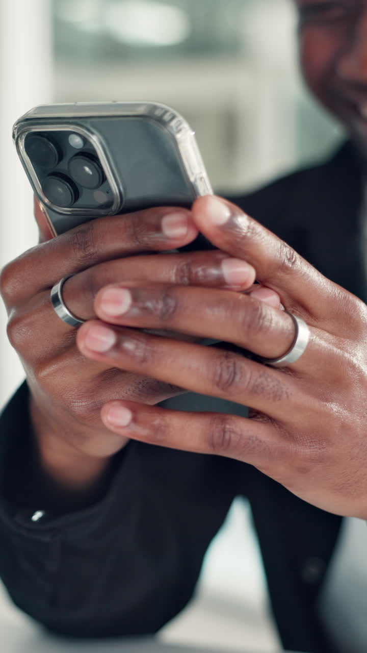 Close-Up of Person's Hands Holding a Smartphone and Smiling