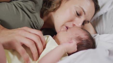 Video-of-happy-caucasian-mother-kissing-newborn-baby