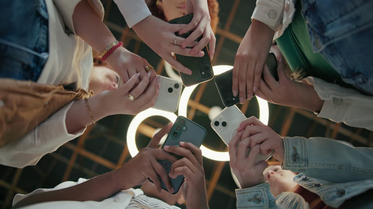 Group of people with mobile phones in a circle