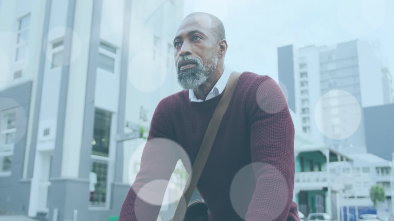 Animation of light spots over african american man cycling