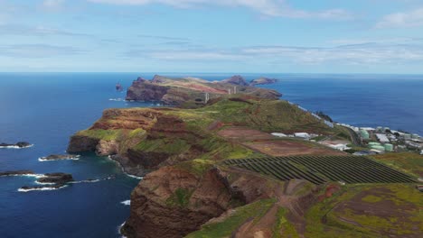 breathtaking aerial view of ponta de sao lourenco, showcasing wind turbines, rugged cliffs, and vast ocean expanse in madeira, portugal