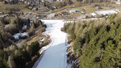 there are winter sports that play the role of the winter olympics in cortina and milano italy. learning to ski and snowboard i capture these videos with my drone that is in a ski resort. green and