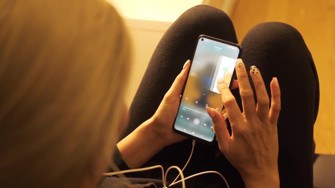 Woman Listening to Podcast on Smartphone