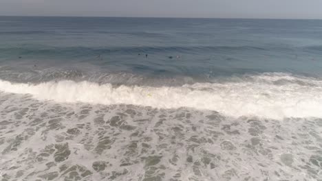 Aerial-shot-of-a-surfer-falling-in-Zicatela-beach-Puerto-Escondido,-Oaxaca