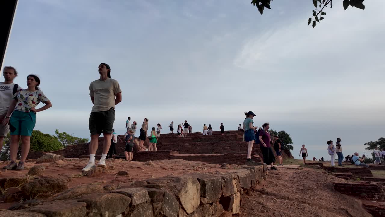 Tourist Walking around on top of Sigiriya rock on overcast morning in sri lanka