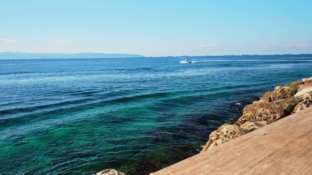Akko old city ocean boardwalk and speeding boat