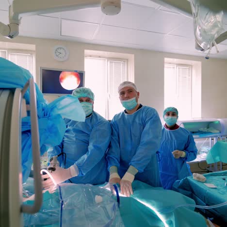 medical team performing surgical operation in bright modern surgery room. operating theatre. modern equipment in clinic