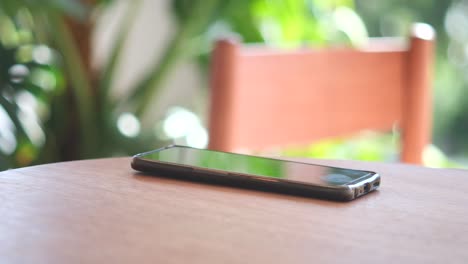 smartphone on a wooden table in a cafe