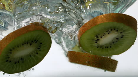 kiwi slices falling into water