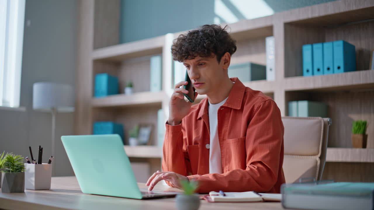 Smiling manager calling work process sitting office desk. Successful businessman