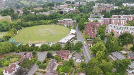 Aerial-reveal-of-the-Devon-and-Exeter-Squash-Club,-showcasing-lush-green-surroundings-and-modern-sports-facilities-in-Exeter,-UK