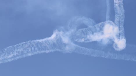 planes executing complex maneuvers with smoke trails