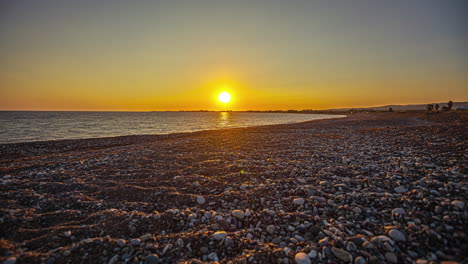 pebble shore of paphos beach during sunset in southwest cyprus