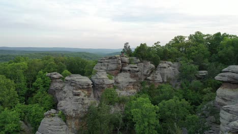 rocky landscape covered in dense forest in aerial drone view