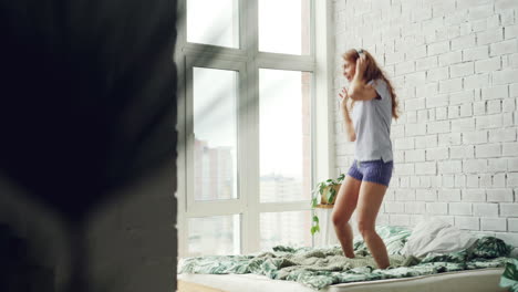 woman dancing in her bedroom
