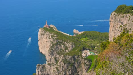 High-angle-shot-over-lighthouse-Faro-Di-Punta-Carena,-Anacapri-on-the-southwest-cape-of-the-island-of-Capri,-Italy-on-a-sunny-day