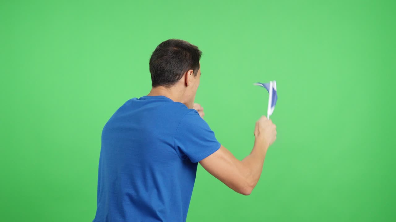 Rear view of a man waving a scottish pennant