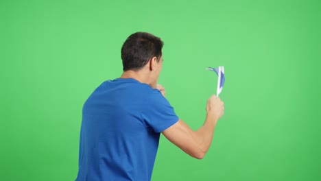 rear view of a man waving a scottish pennant