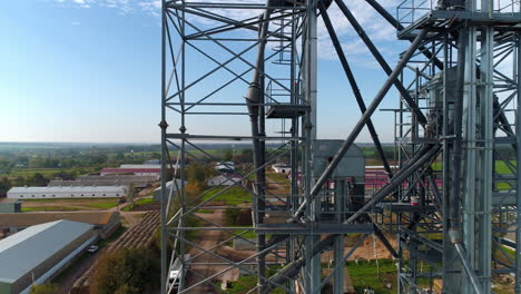 steel frame in the industrial territory. industrial plant in farmland. grain elevators and metal equipment of a factory. view from above.