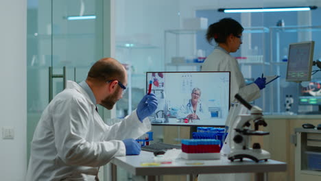 male chemist listening professional doctor on video call