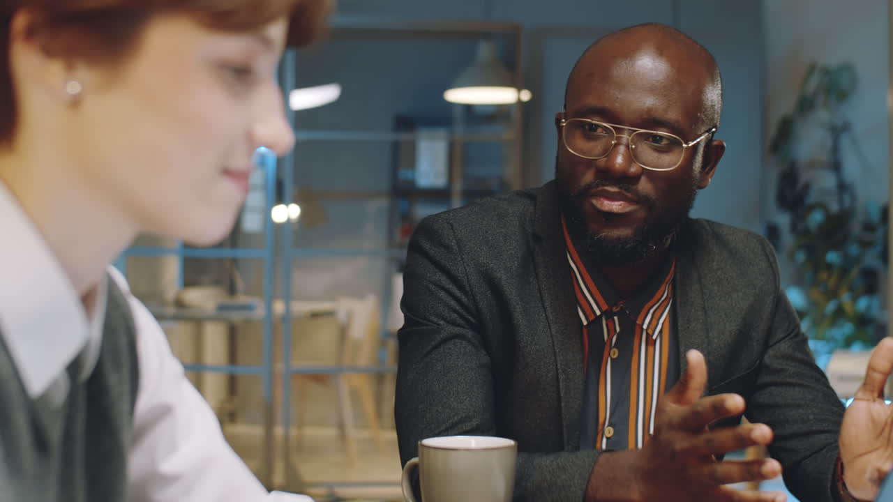 African American Businessman Talking with Colleague at Night Meeting
