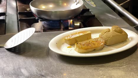 variety of ingredients being cooked in a commercial kitchen: red mullets, foie gras, spaghetti, ratatouille