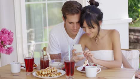 woman sharing with man something on her phone