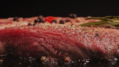 close-up of seasoned steak cooking in a pan