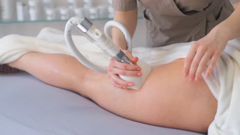 cosmetologist makes woman cavitation vacuum roller massage on back correction figures in spa clinic cosmetologist doctor makes a woman cavitation lpg vacuum roller massage procedure on back correction female figures in spa salon clinic improving body figure shapes weight loss lymph drainage