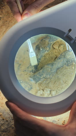 archaeological excavation under magnifying glass