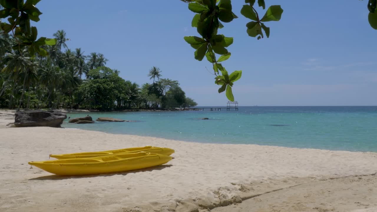 Two yellow kayaks on the beach