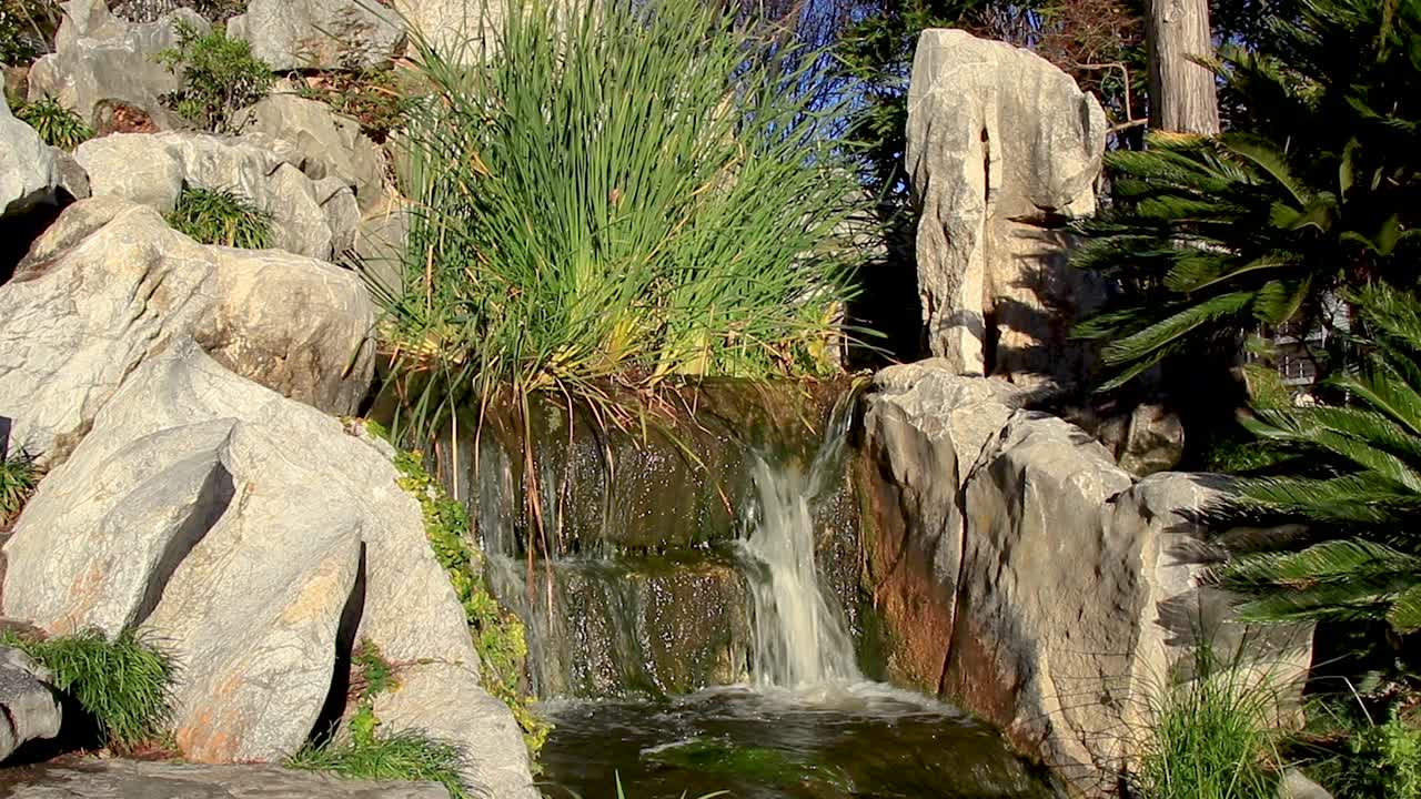 Waterfall flowing over rocks in a Chinese garden on a summers day