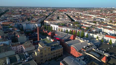 berlin's urban landscape, capturing a mix of residential and commercial buildings, streets, and green spaces. unbelievable aerial view flight fly reverse drone