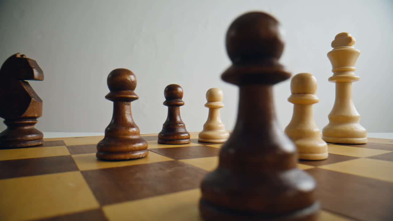 Closeup hand moving pawn piece chess board. Person playing logic strategy game