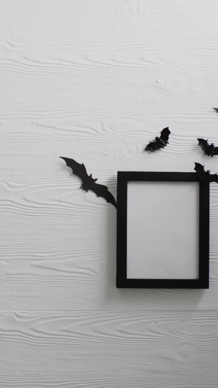 Vertical video of black frame with bats with copy space on white background
