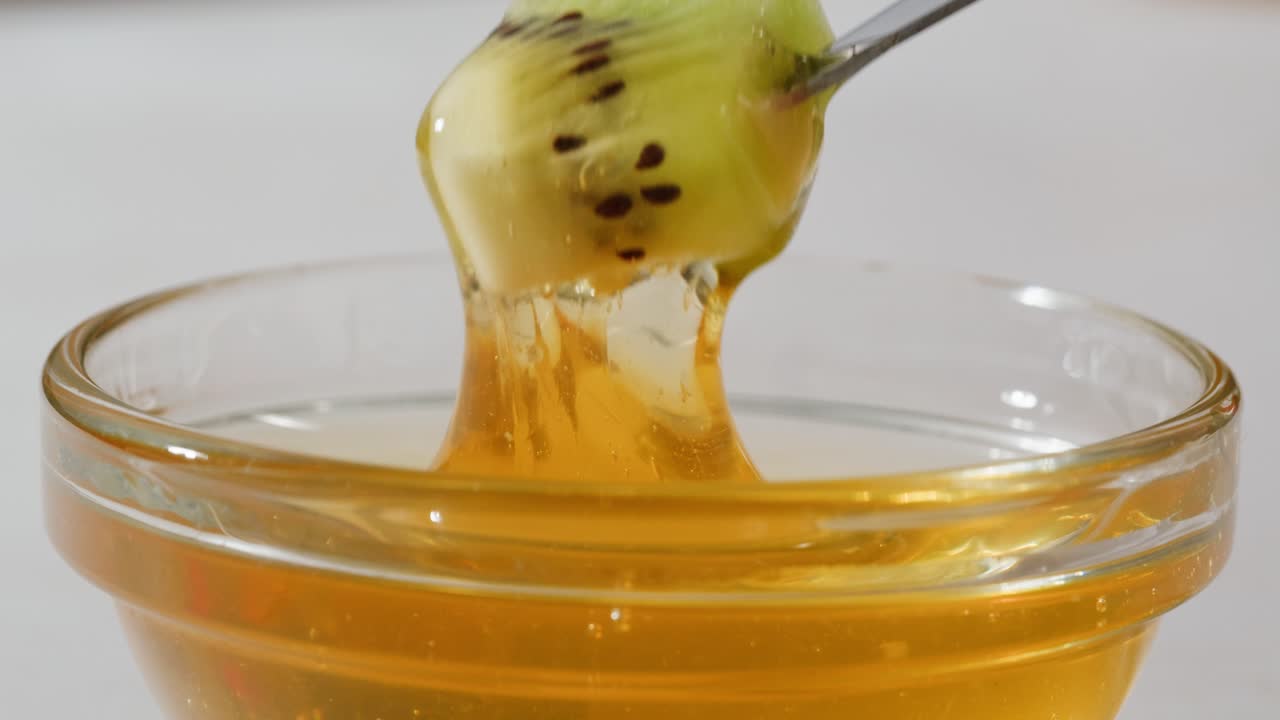 Kiwi Dipping in Honey
