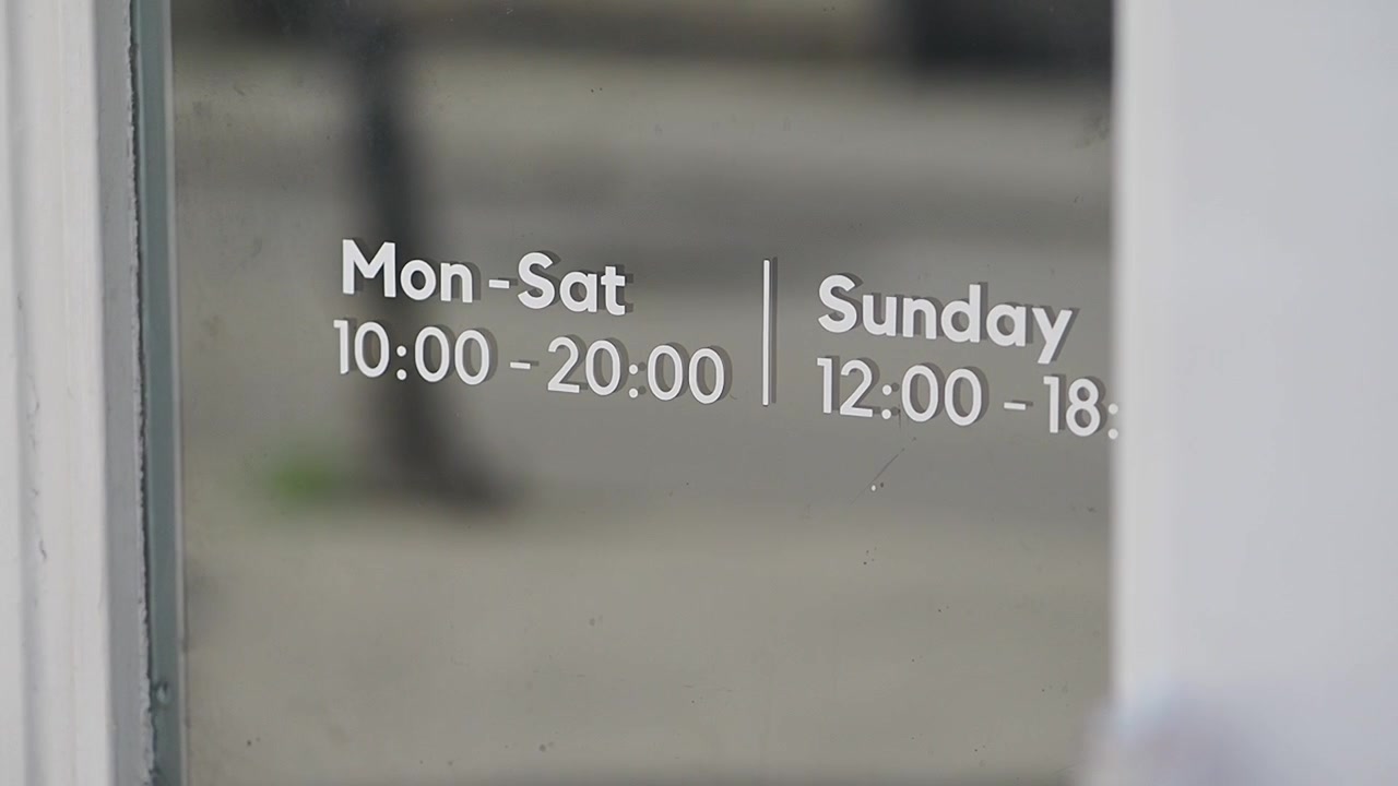 Store Opening Hours Displayed on Glass Door