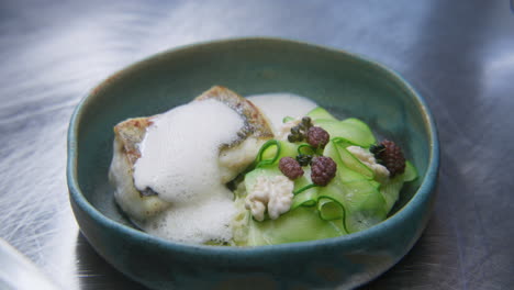 gourmet fish dish with zucchini and foam