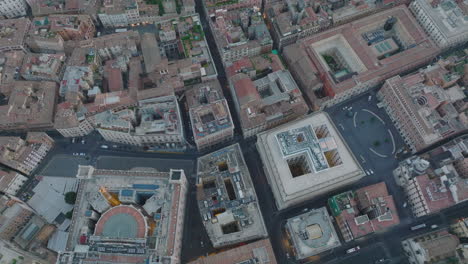 Birds-eye-shot-of-old-houses-and-palaces-in-city-centre-at-twilight.-Fly-above-various-buildings-in-urban-borough.-Rome,-Italy