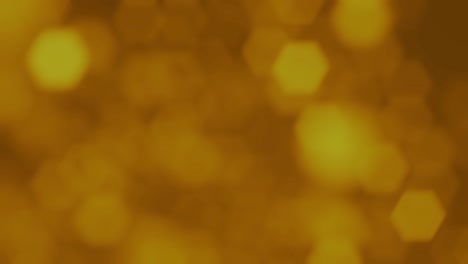 fundo de movimento abstrato partículas de ouro brilhantes. partículas brilhantes cintilantes com bokeh. ano novo e fundo de natal. animação de vídeo de loop 4k sem costura