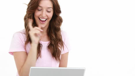 Smiling-woman-using-laptop-