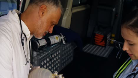 emergency medical technician placing an oxygen mask